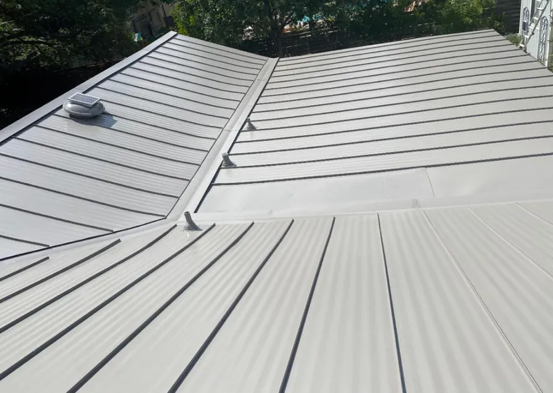 Solar attic fan installed on a metal roof for Roof Ventilation in Beverly
